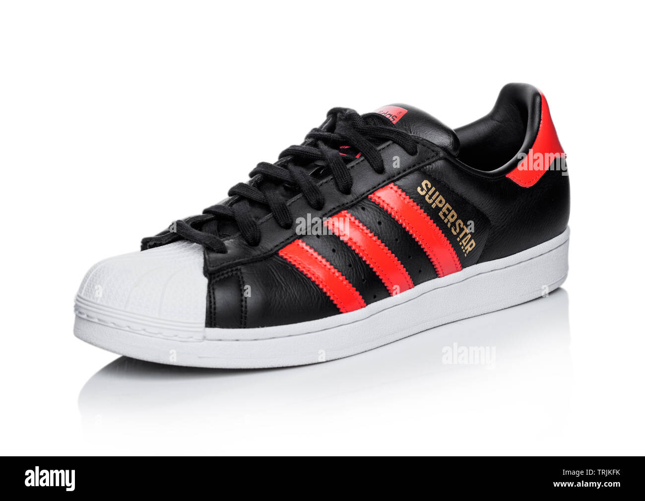 LONDON, UK JUNE 05, 2019: Adidas Originals Superstar black shoe with red stripes on background Stock Photo Alamy
