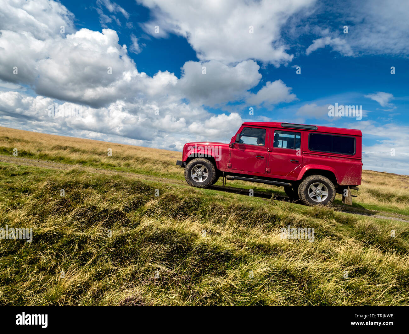Red Land Rover Defender 110 4WD car navigating a Green Lane track, North Yorkshire Moors, UK. Stock Photo