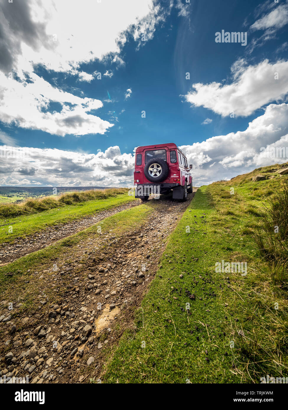 Red Land Rover Defender 110 4WD car navigating a Green Lane track, North Yorkshire Moors, UK. Stock Photo