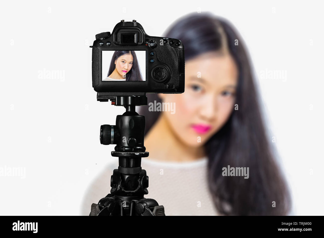 Focus on live view on camera on tripod, teenage girl makeup beauty shoot image on back screen