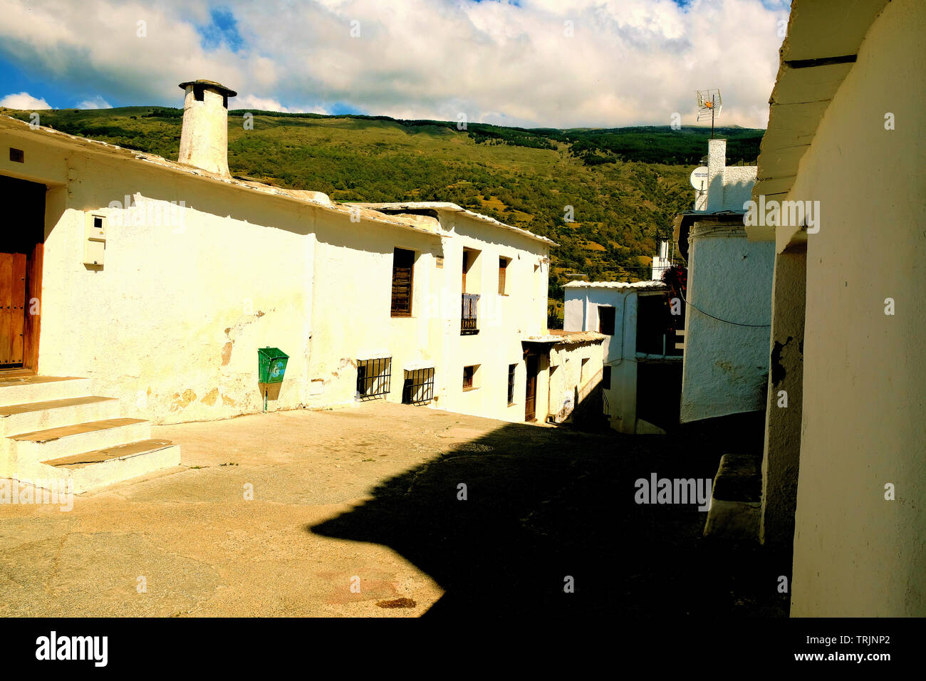 Street with rustic whitewashed homes in the Sierra Nevada village of