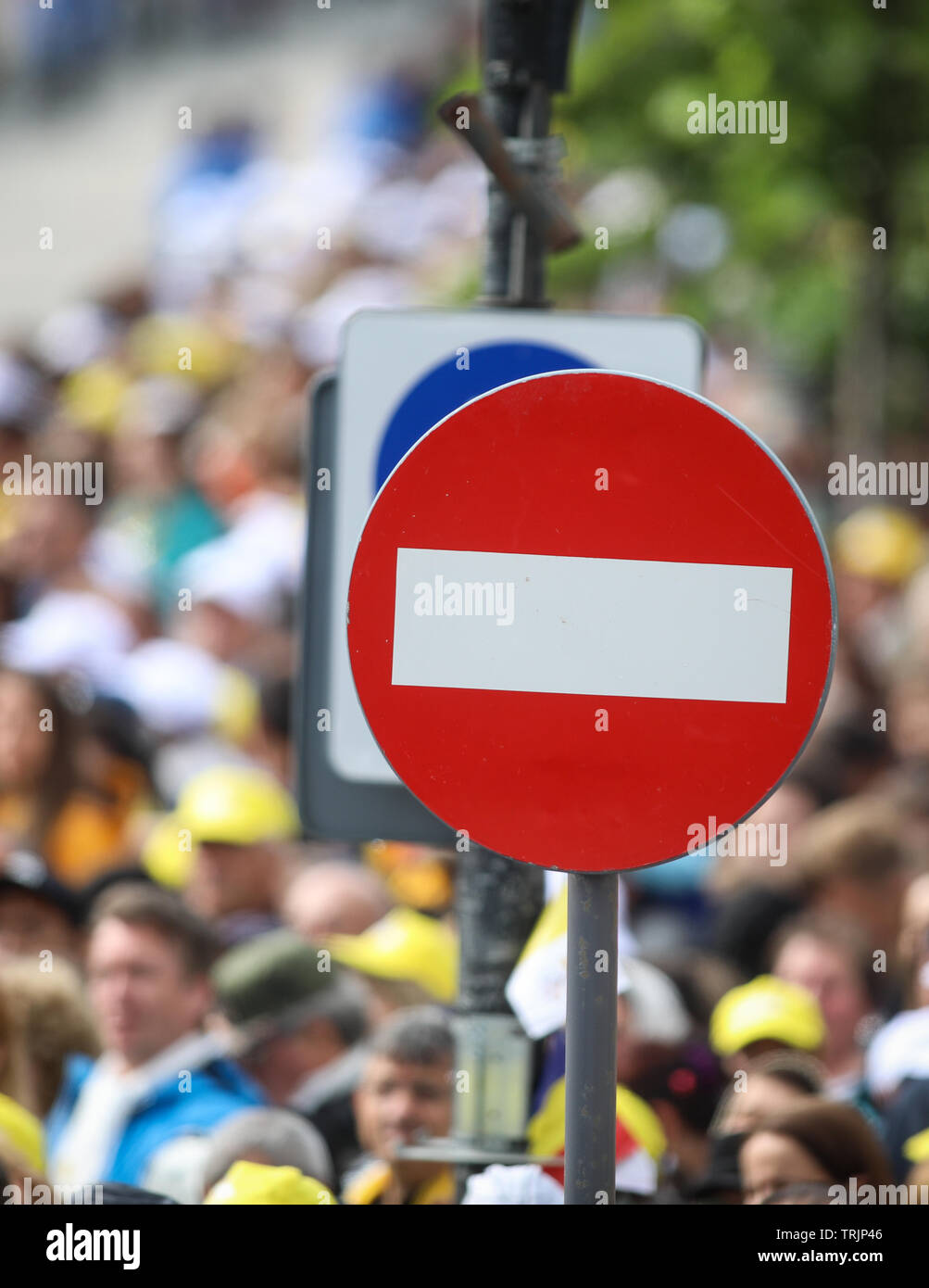 Access denied road sign with a large mass of people in the background - social or mass control Stock Photo