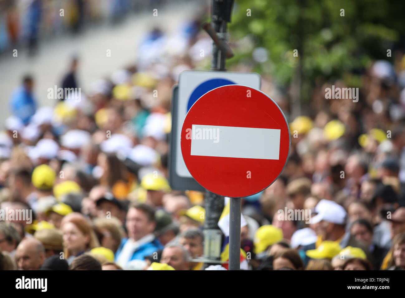 Access denied road sign with a large mass of people in the background - social or mass control Stock Photo