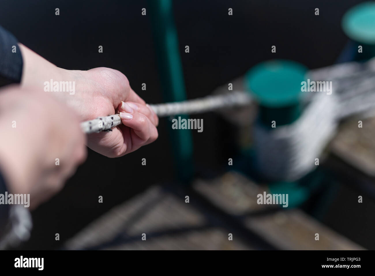 Close up of female hands holding boat rope Stock Photo