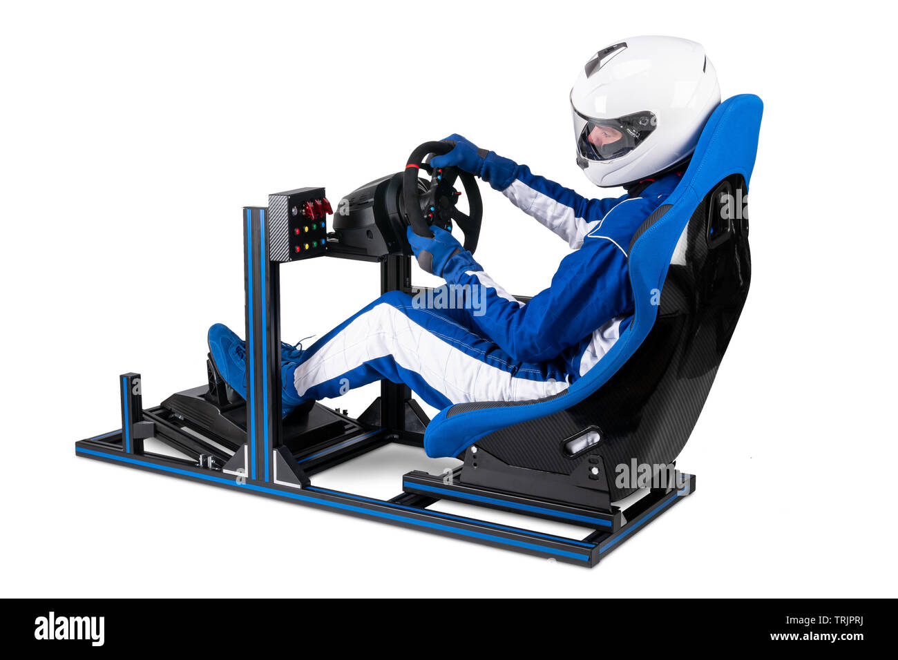 race driver in blue overall with helmet taining on simracing aluminum simulator rig for video game racing. Motorsport car bucket seat steering wheel p Stock Photo