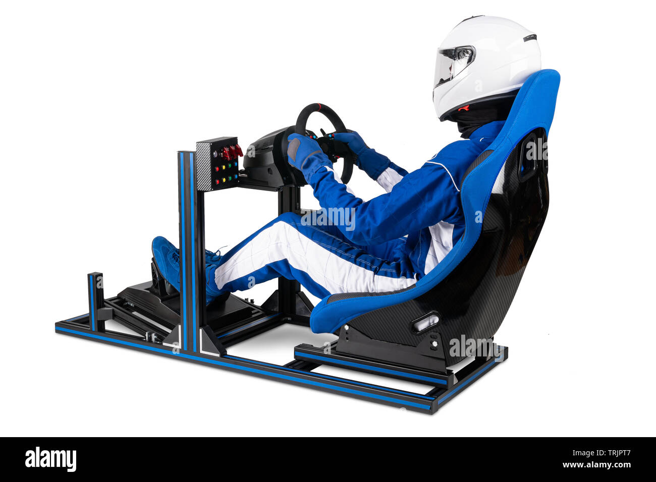 race driver in blue overall with helmet taining on simracing aluminum simulator rig for video game racing. Motorsport car bucket seat steering wheel p Stock Photo