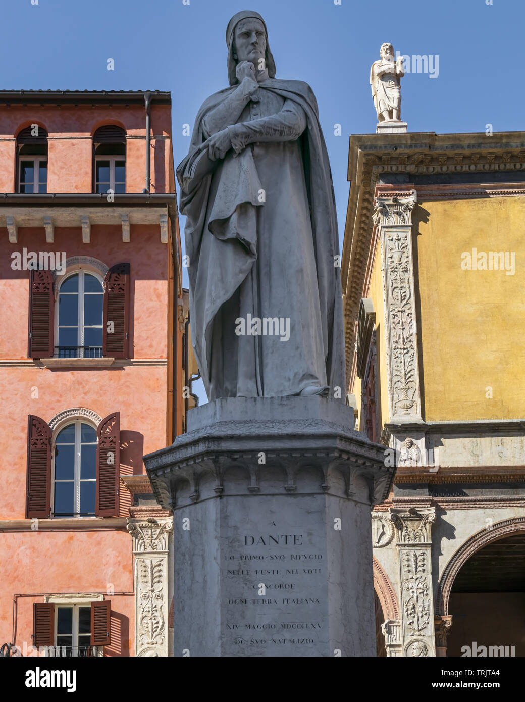 The Statue of Dante Alighieri in a square in Verona sandwiched between two buildings on a bright summer day in the sun Stock Photo