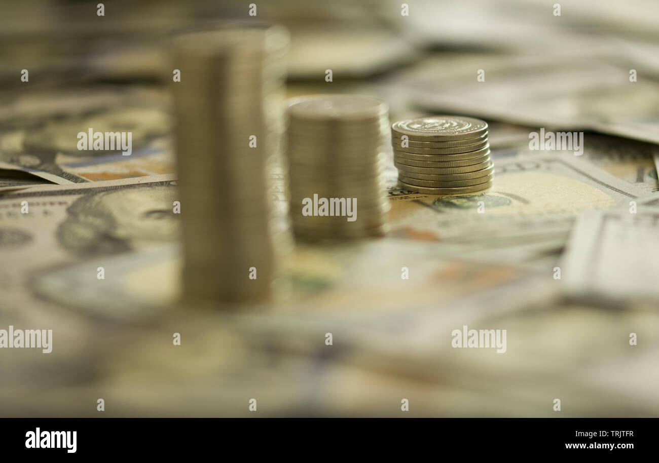 Coins Stack on the one hundred dollars banknotes. Financial growth concept. concept of strategy of profit or benefit making in business. Stock Photo