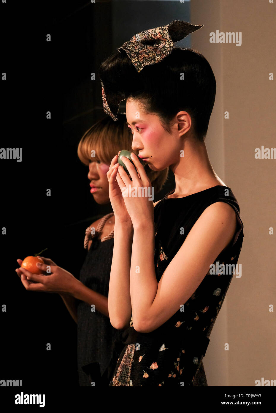 Chinese model smells object at the Livia Tang Autumn Winter 2019 Presentation during London Fashion Week at the Freemason's Hall Stock Photo