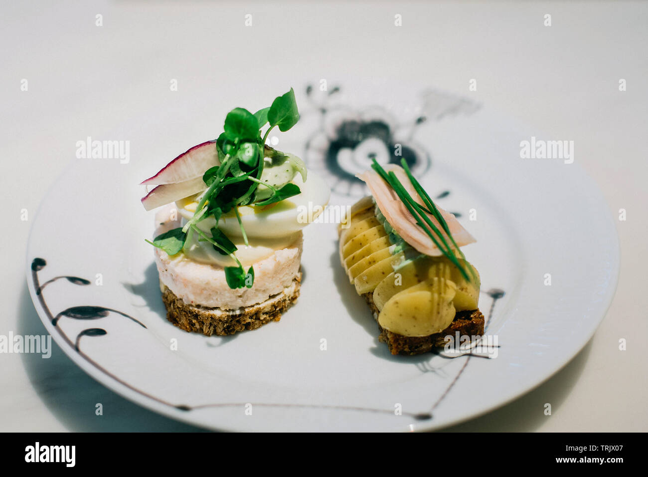 Traditional, open faced sandwiches on a ceramic plate in Denmark