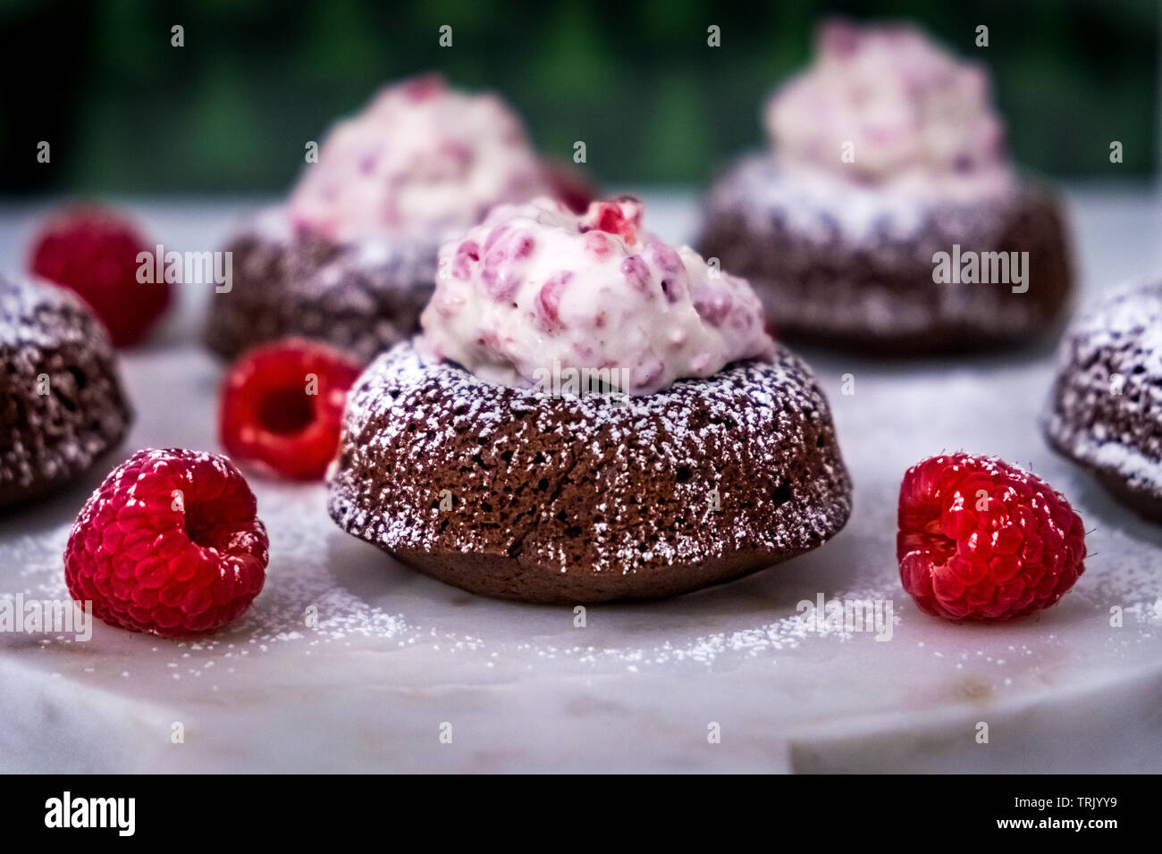 Decadent Chocolate Doughnut Topped with Vanilla Raspberry Ice Cream and Dusted with Powdered Sugar Stock Photo