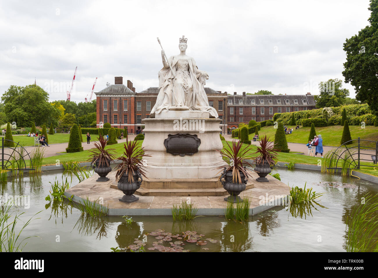 Kensington Palace and Queen Victoria statue, Kensington Gardens, London, England, United Kingdom. Stock Photo