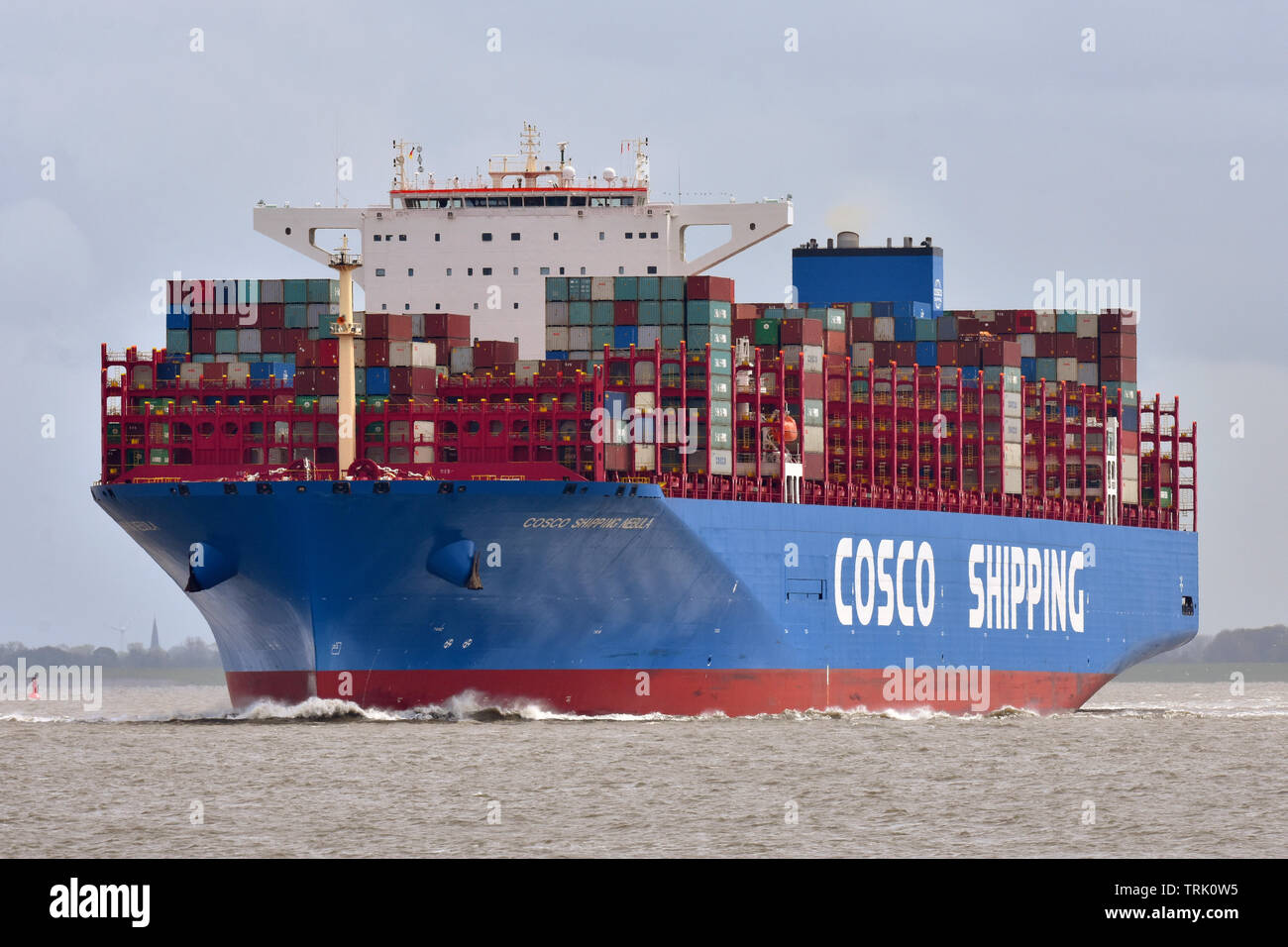 COSCO Shipping Nebula passing Cuxhaven outward bound from Hamburg Stock Photo