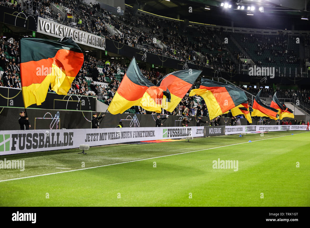 Wolfsburg, Germany, March 20, 2019: big German flags waving at the Volkswagen Arena before the international soccer game Germany VS Serbia. Stock Photo
