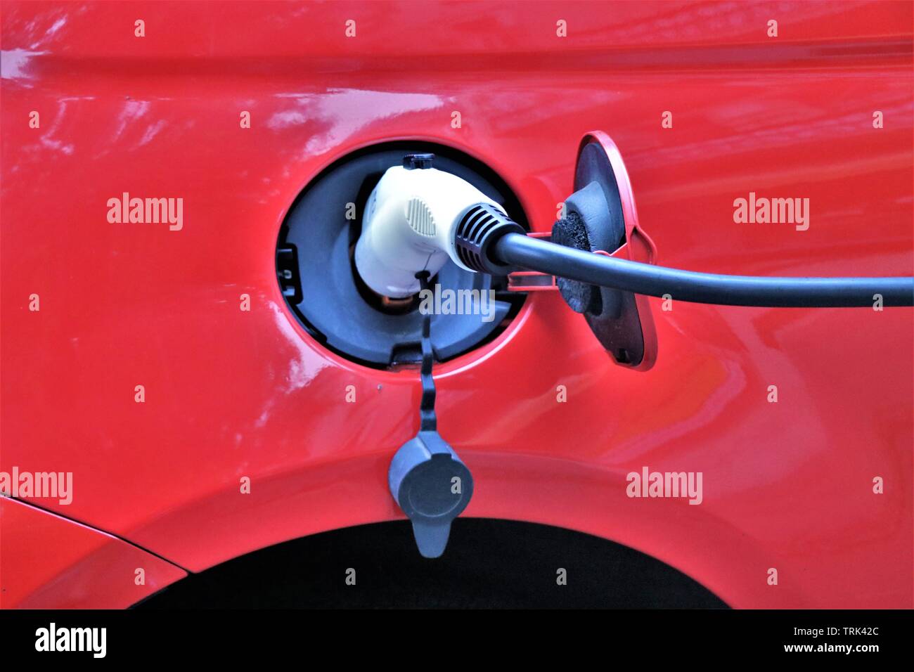 Charger point for electrical car. The future against the pollution. Car connected to the electric current. Stock Photo