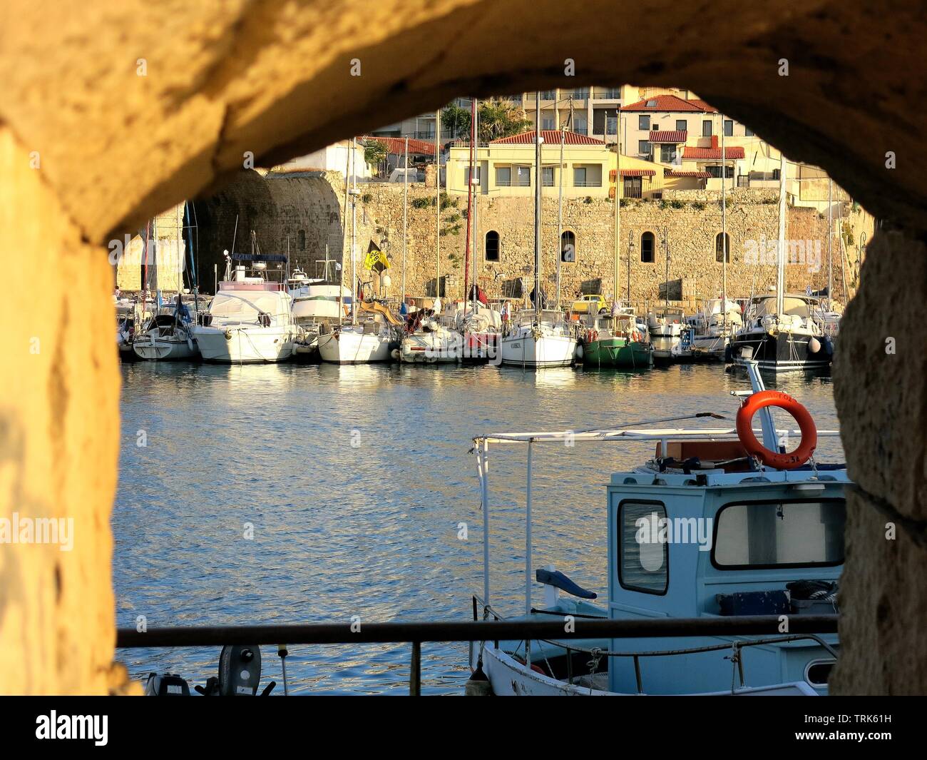 Part of the old port of Heraklion, Crete as seen from one of the port holes of the Venetian fortifications of Koules. Stock Photo