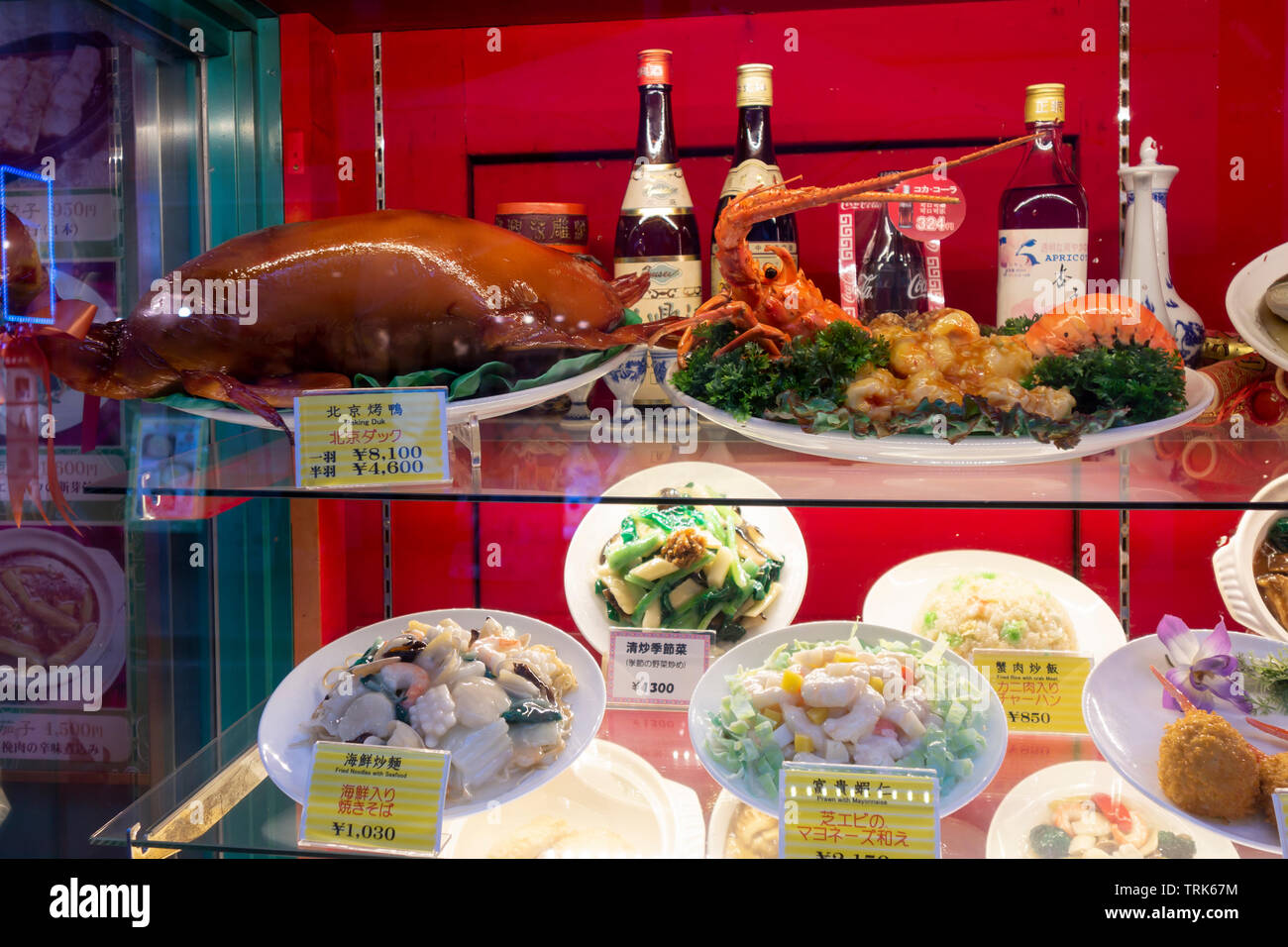 Fake plastic food on a restaurant display vitrine. Showing the food in a realistic way is typical in most Japanese res Stock Photo