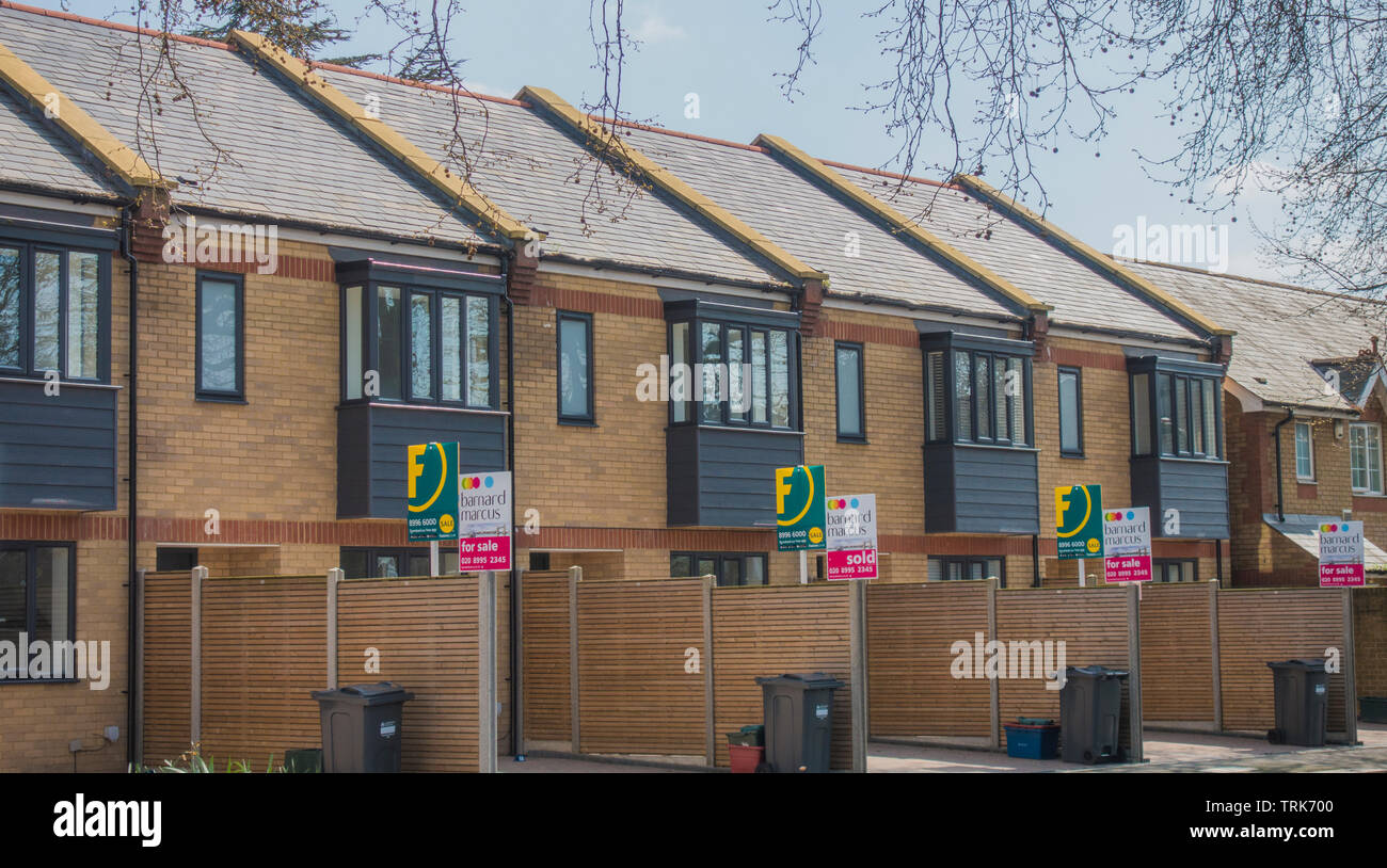 Foxtons and Barnard Marcus estate agents for sale boards outside a
