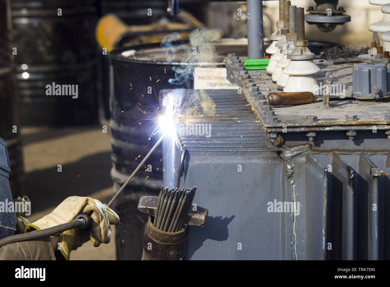 welder repairing an electrical transformer. electrical equipment
