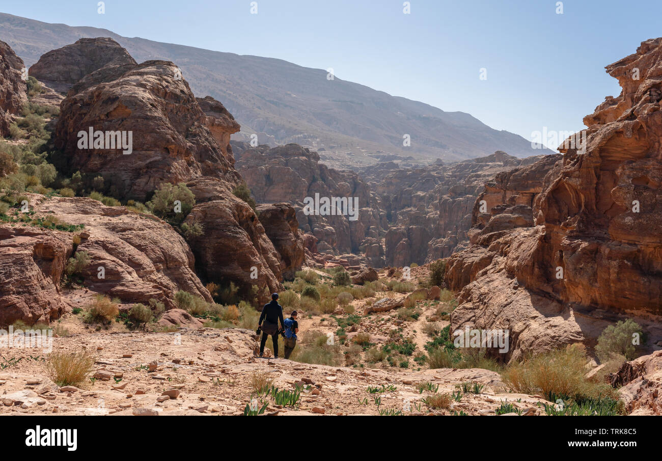 Travelers with backpack hiking in Petra the rose city in Jordan, Middle East. Travel lifestyle and adventurous concept Stock Photo
