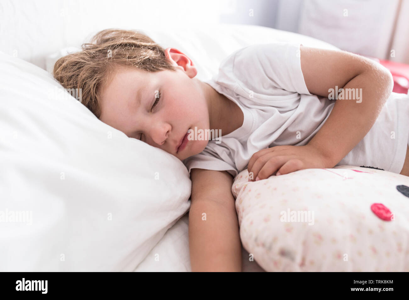 3 years toddler boy sleeping the siesta on bed. Selective focus Stock
