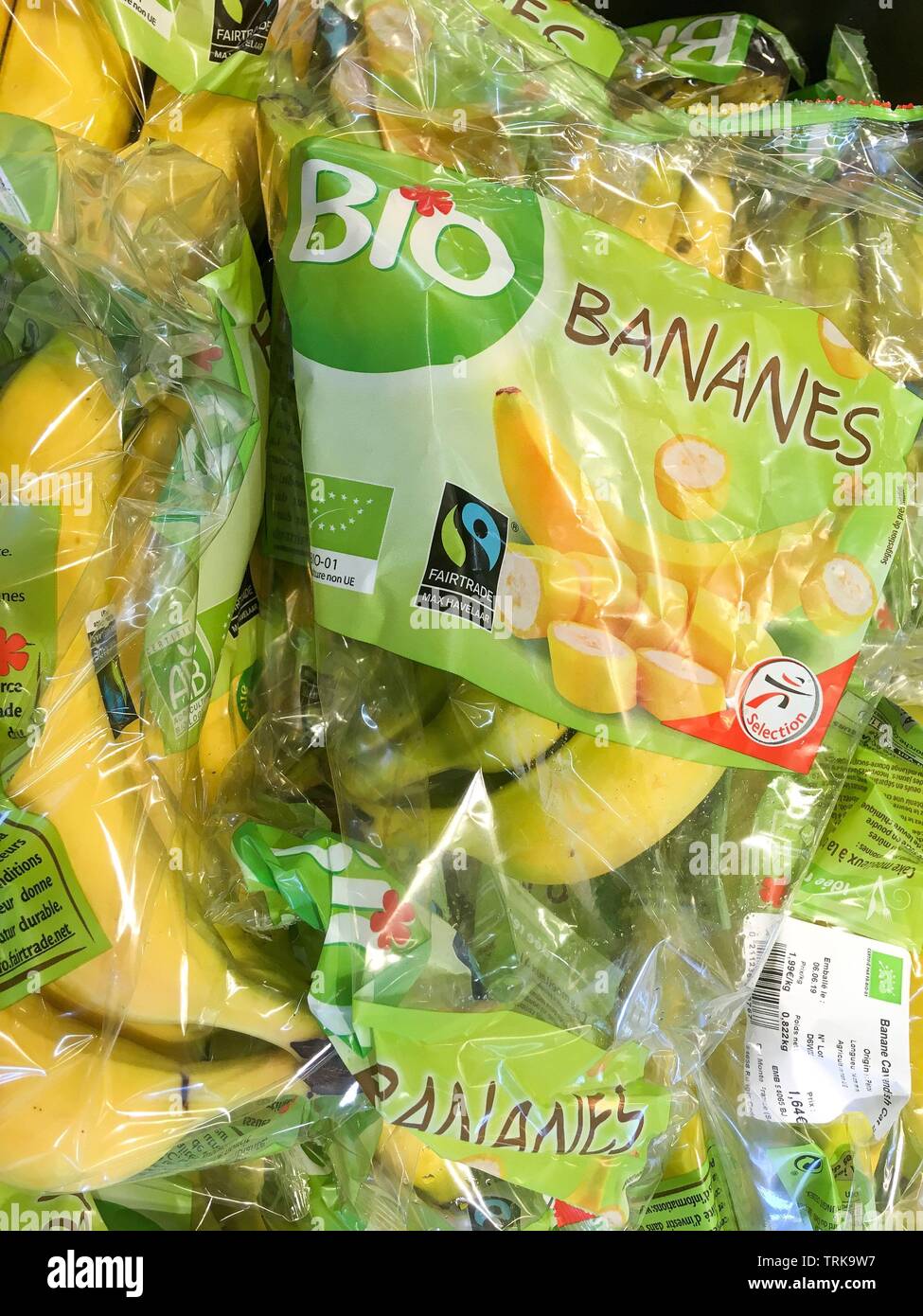 Organic bananas packaged in plastic blister packs, France Stock Photo