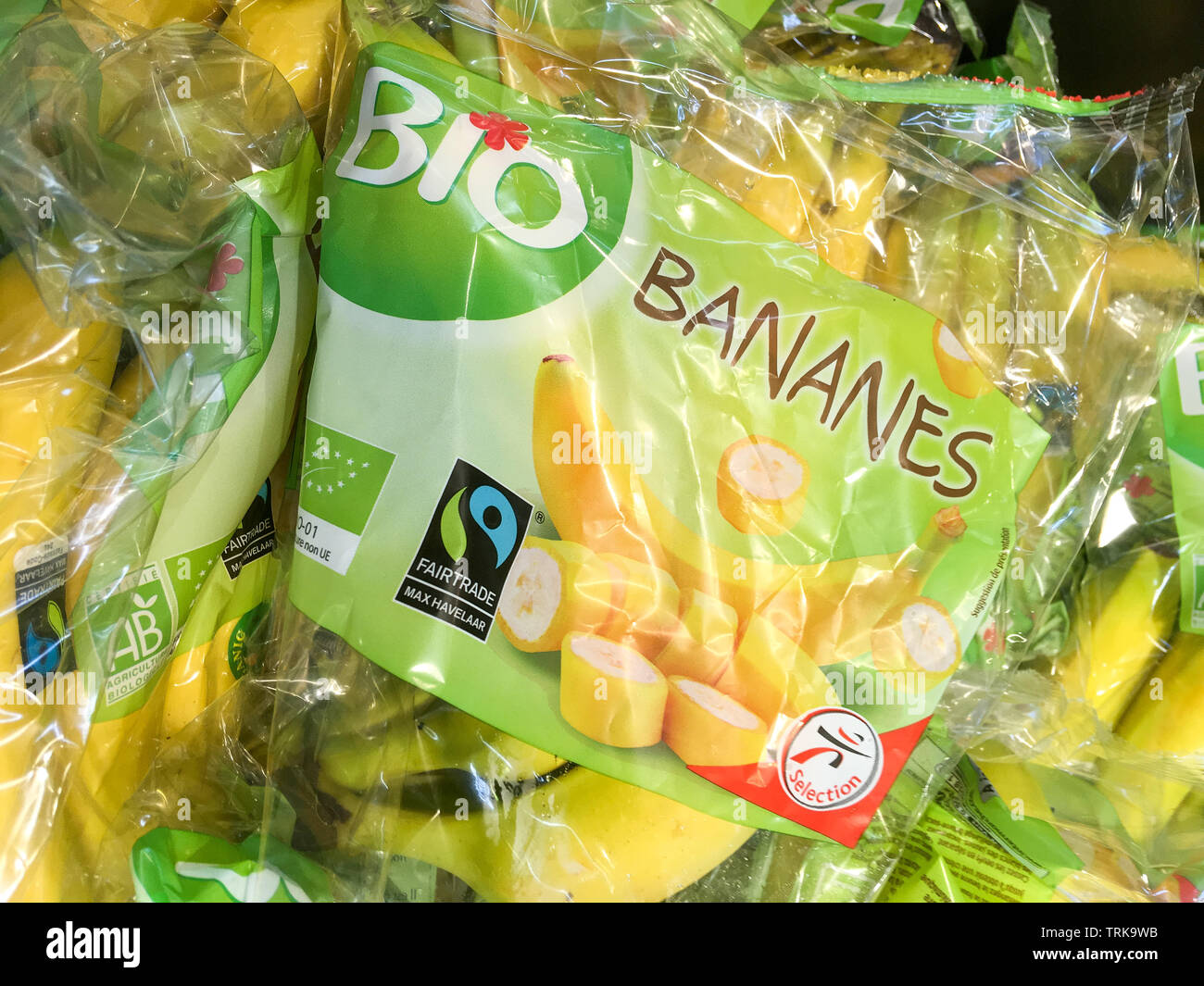 Organic bananas packaged in plastic blister packs, France Stock Photo