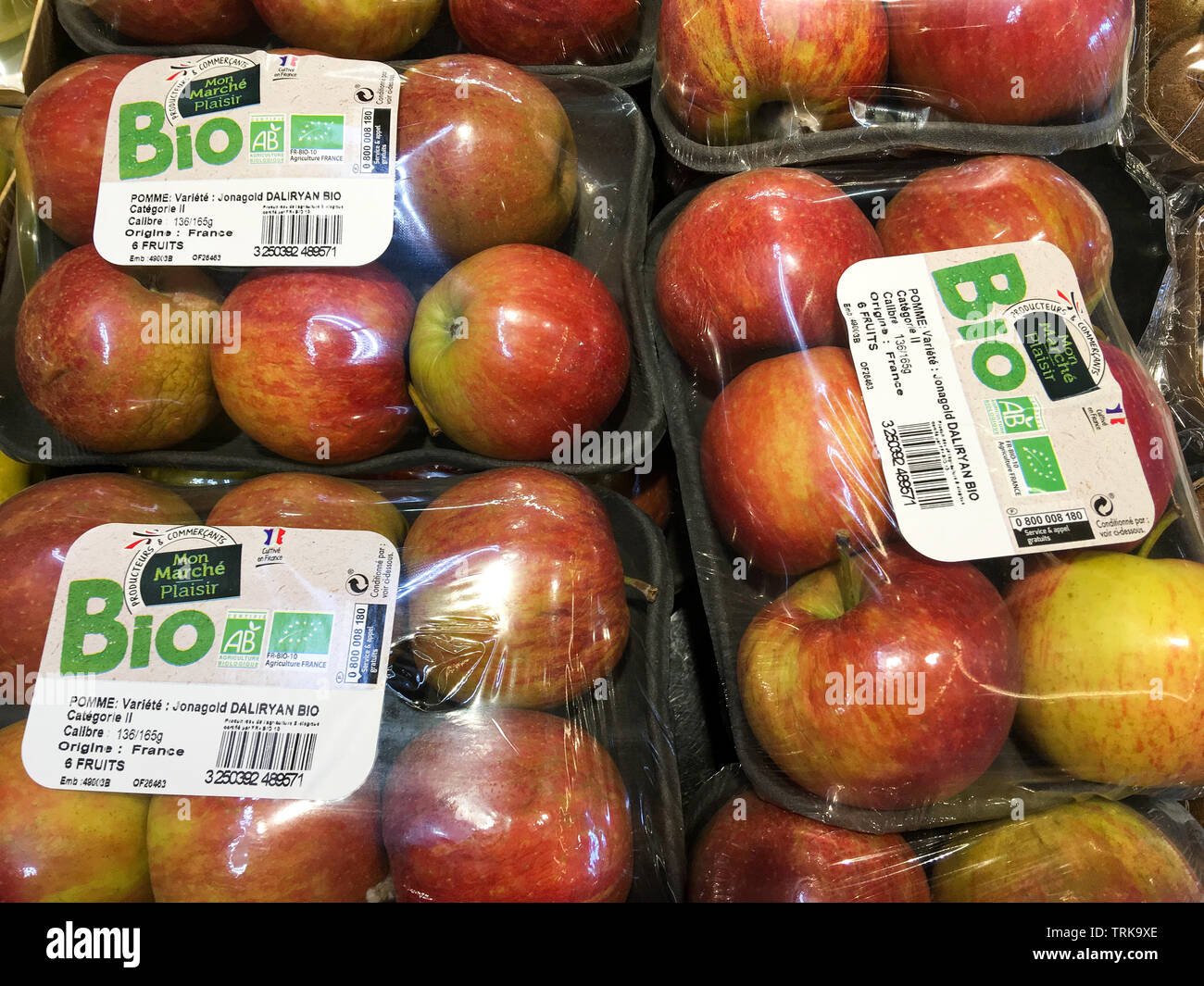 Organic apples packaged in plastic blister packs, France Stock Photo