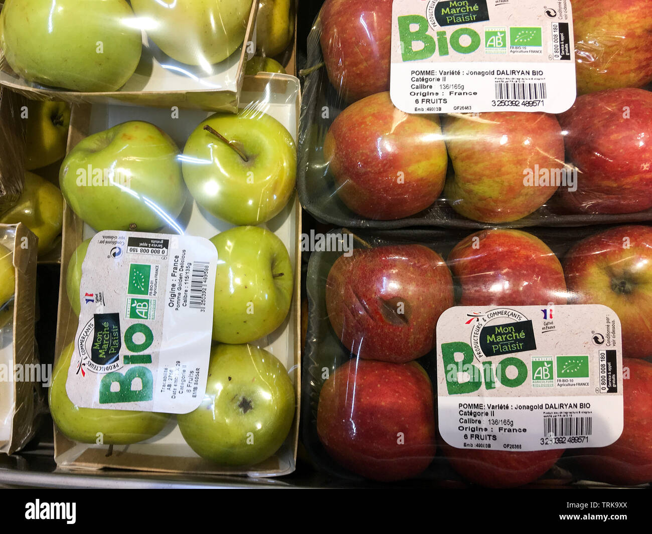 Organic apples packaged in plastic blister packs, France Stock Photo
