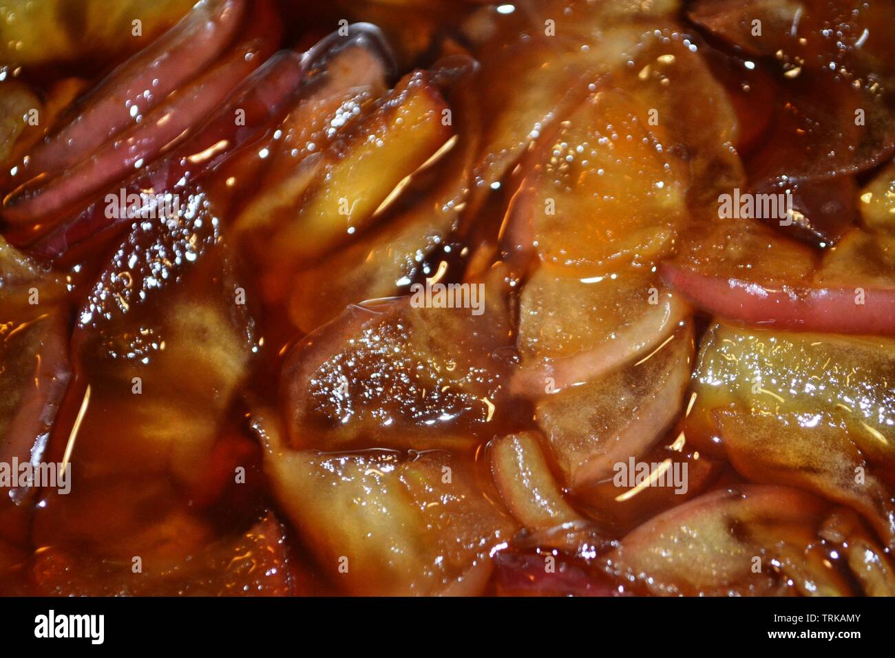Blur background of apple slices cooked in stove with sugar at high