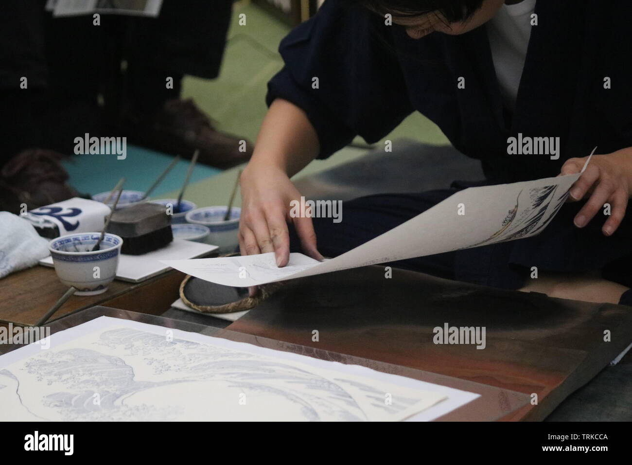 Girl recreating the Japanese ukiyo-e artist Hokusai's  woodblock The Great Wave off Kanagawa Stock Photo