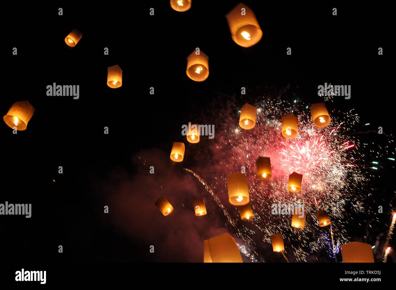 Festival Lantern lift-off with fireworks Stock Photo