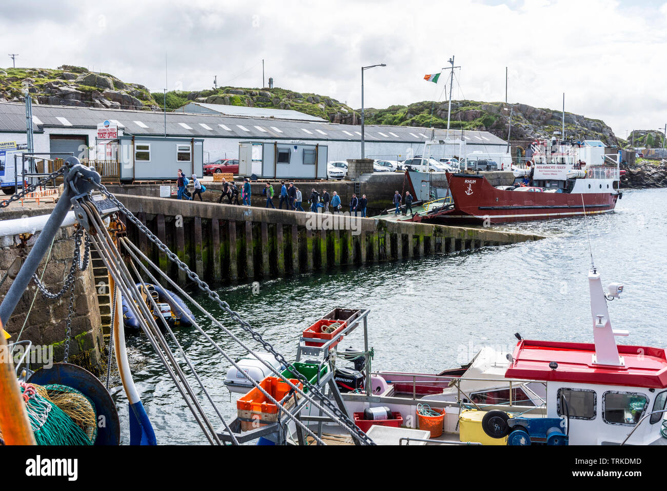 Foot passengers and vehicles disembark from Arranmore Island Ferry at Burtonport harbour, County Donegal, Ireland Stock Photo