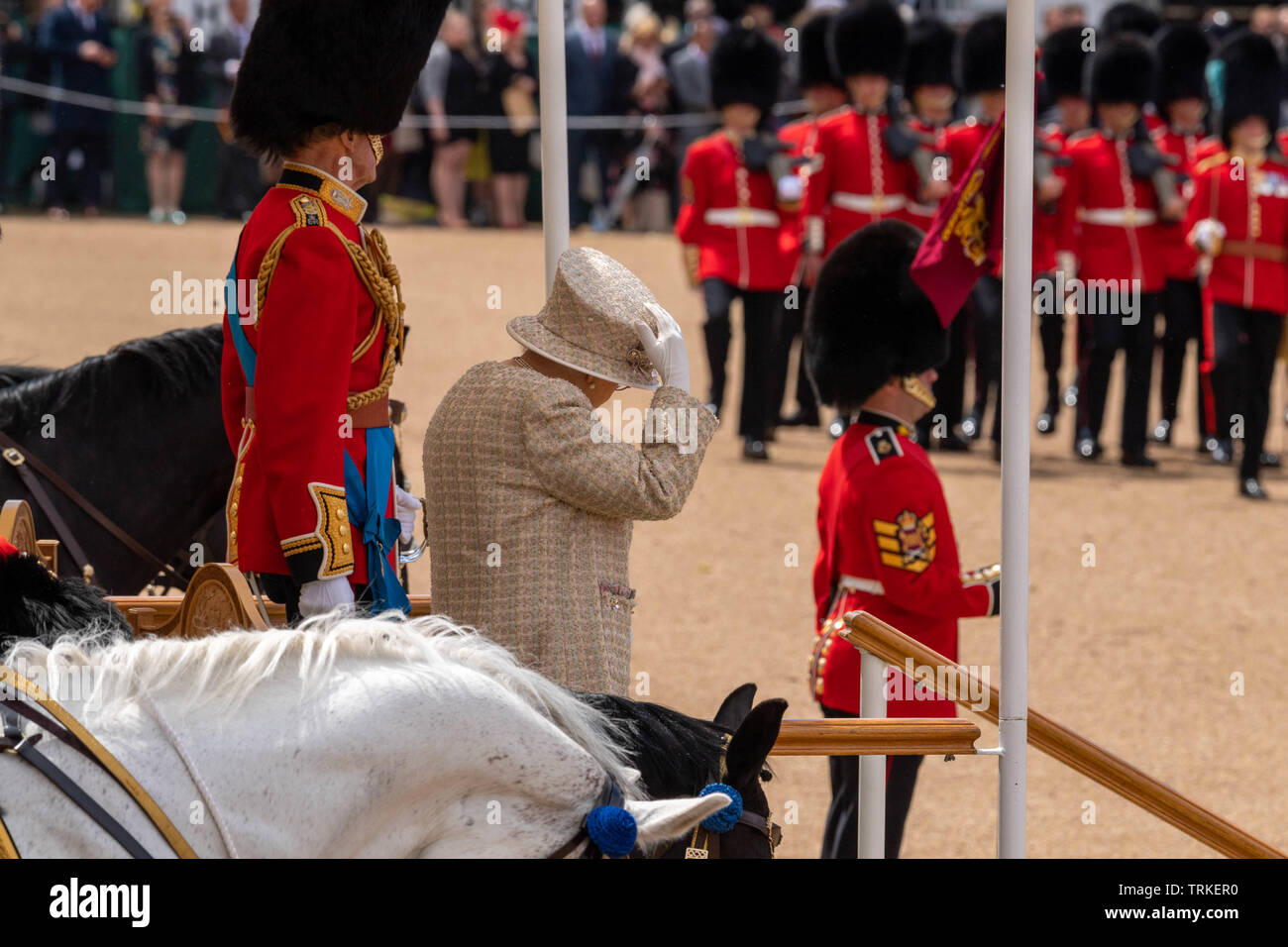 London, UK. 8th June 2019 Trooping the Colour 2019, The Queen's Birthday parade on Horseguards Parade London in the presence of Her Majesty The Queen.  Colour trooped by the 1st Battalion Grenadier Guards HM The Queen had difficulty keeping her hat on in the breeze Credit Ian Davidson/Alamy Live News Stock Photo