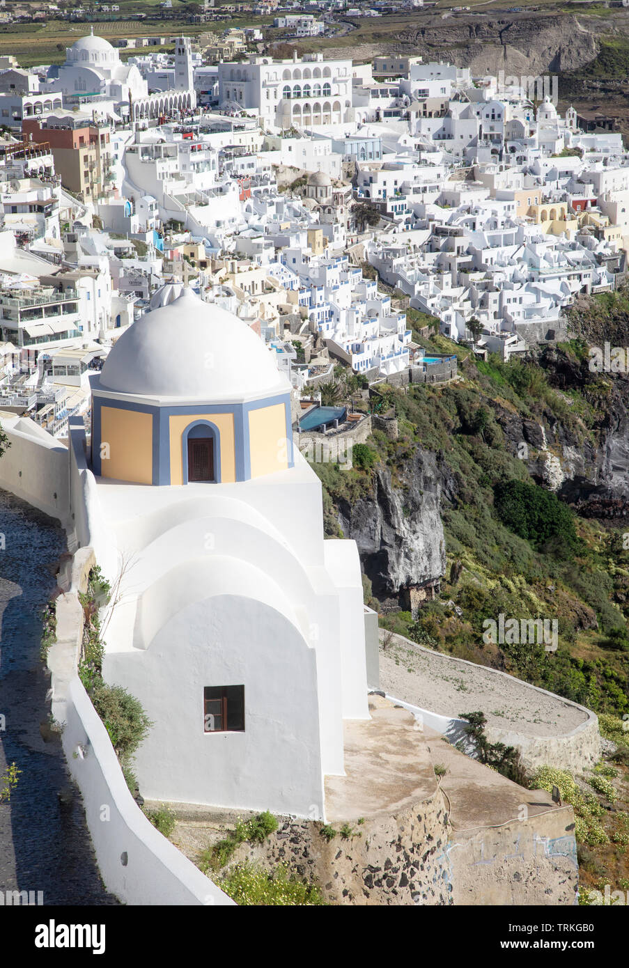 Fira clings to the cliffs above the Aegean Sea in Santorini, Greece. Stock Photo
