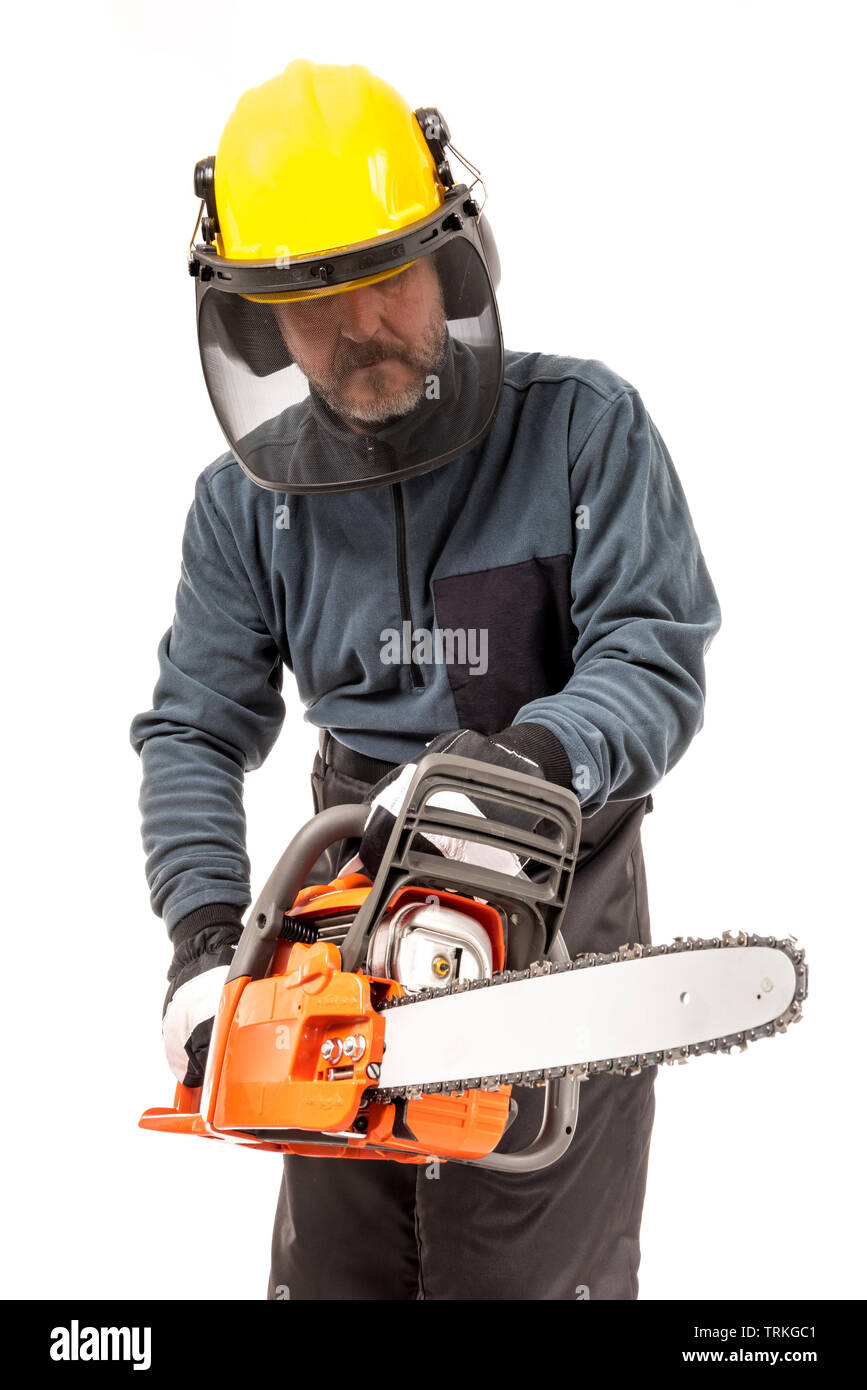 Man in safety gear holding chainsaw Stock Photo