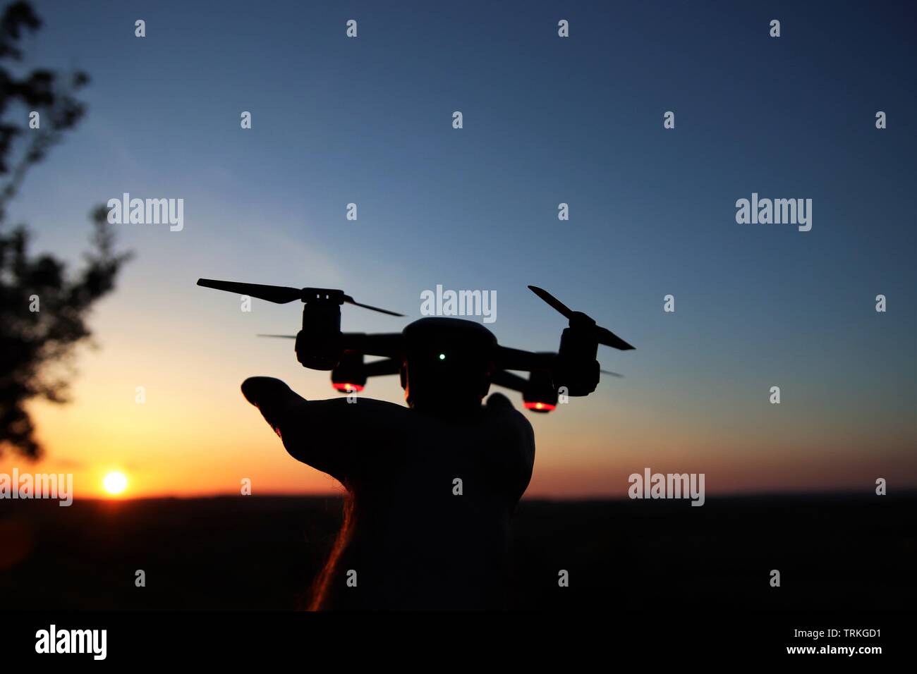 Drone launching from hand at night Stock Photo