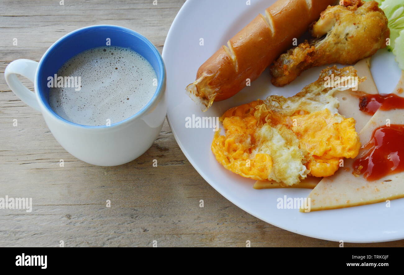 deep fried egg and sausage dressing tomato sauce and coffee Stock Photo