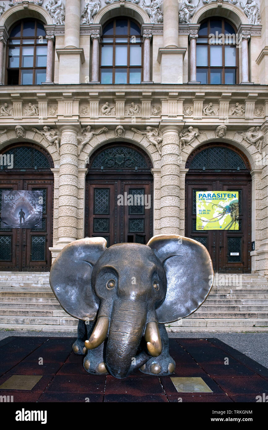 Bronze sculpture of a small elephant with playful dimensions in front