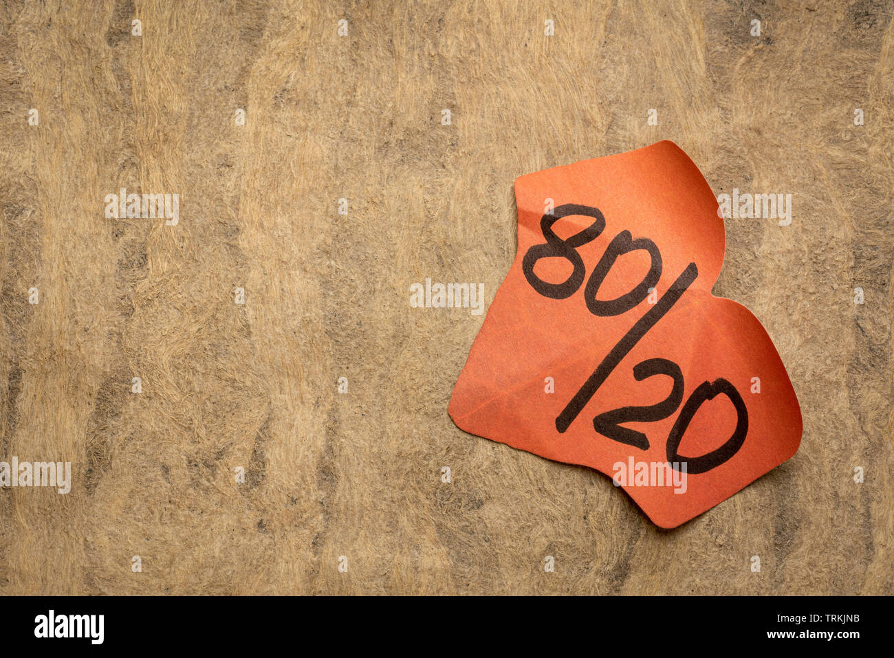 Pareto principle or eighty-twenty rule - leaf shaped sticky note against textured paper - a reminder or advice Stock Photo