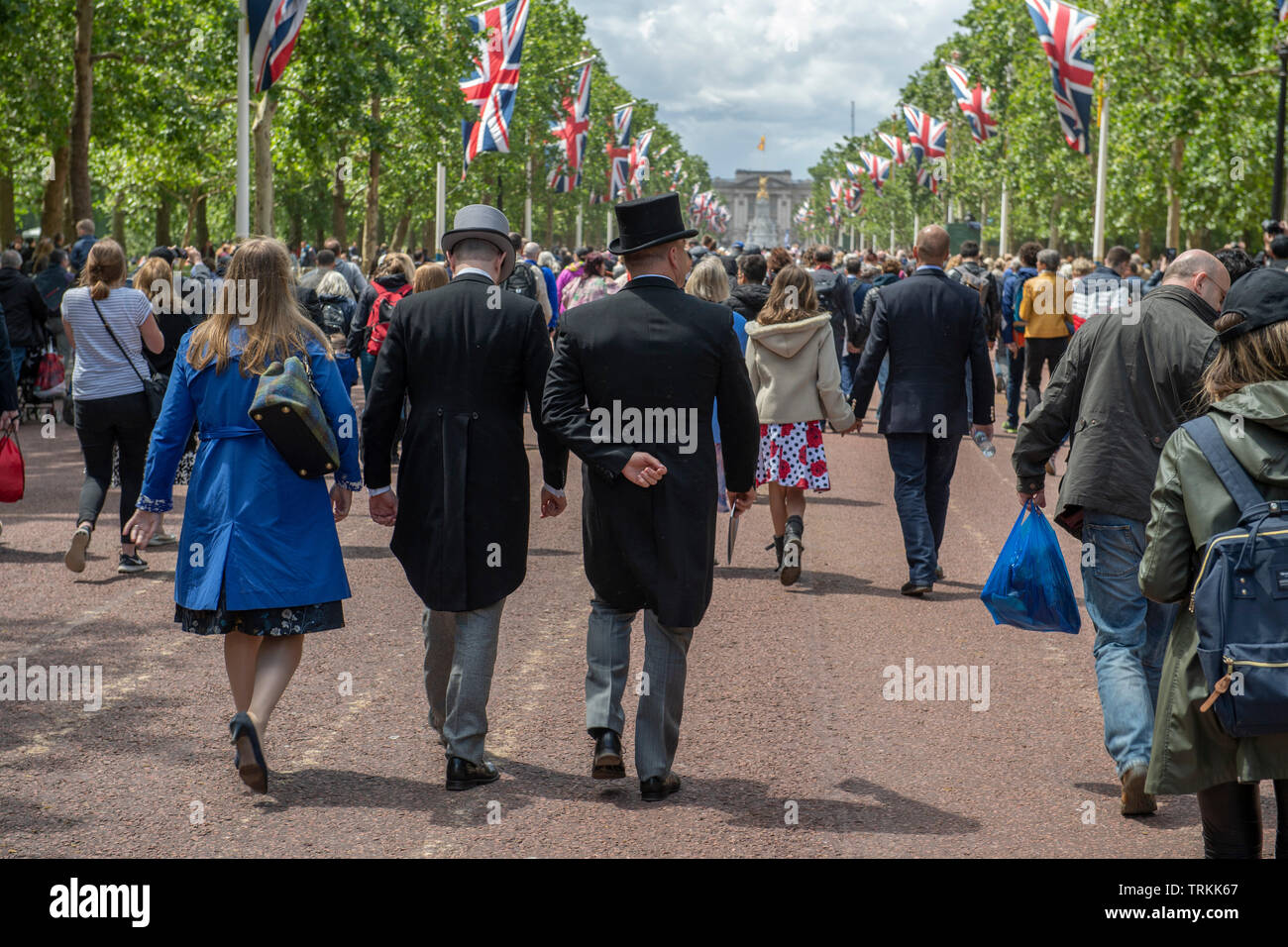 The Mall, London, UK. 8th June 2019. Guests leaving Horse Guards Parade after Trooping the Colour walk to Buckingham Palace along The Mall to watch the traditional RAF fly-past and catch a glimpse of the Royal Family on the palace balcony. Credit: Malcolm Park/Alamy Live News. Stock Photo