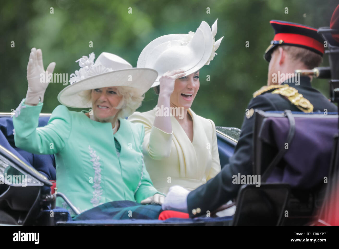 London, UK. 08th June, 2019. HRH Catherine, Duchess of Cambridge and HRH Camilla, Duchess of Cornwall, keep hold of their hats while sharing an open top carriage along The Mall on a windy day. Trooping the Colour, The Queen's Birthday Parade, London UK Credit: amanda rose/Alamy Live News Credit: amanda rose/Alamy Live News Stock Photo