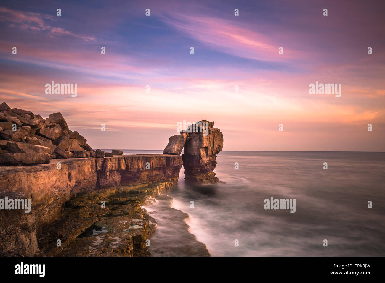 Sunset over Pulpit Rock at Portland Bill on the Isle of Portland near Weymouth on Dorset's Jurassic Coast. England. UK. Stock Photo