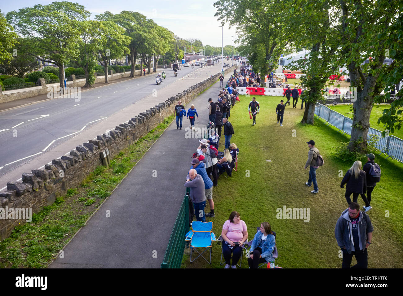 Local people gather to watch the Senior TT race near the grandstand, Douglas, Isle of Man Stock Photo