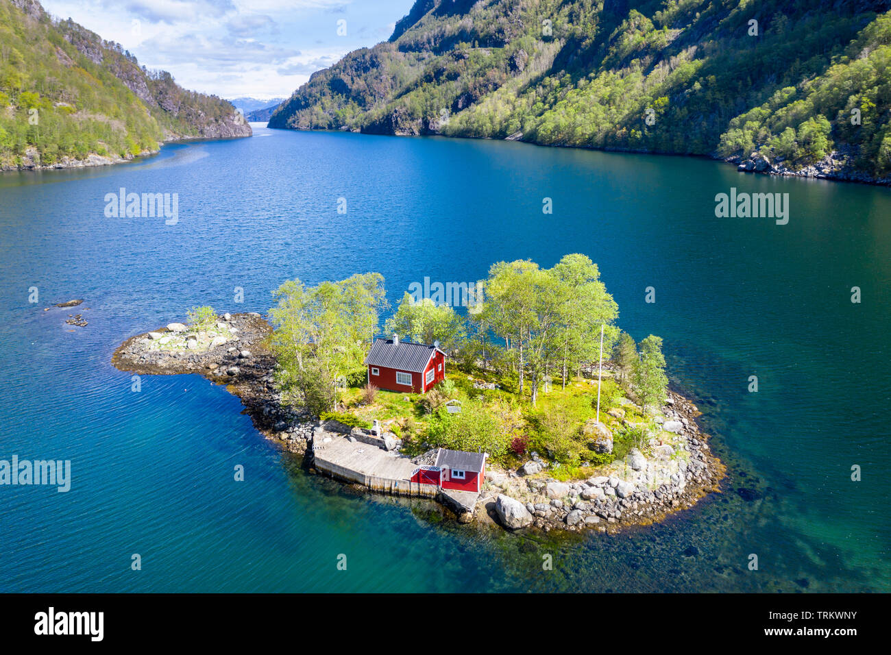 Typical Red Norwegian Cottage On A Little Island In The Fjord