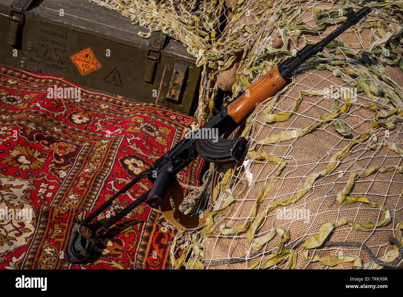 Kalashnikov rifle with a box of ammunition Stock Photo
