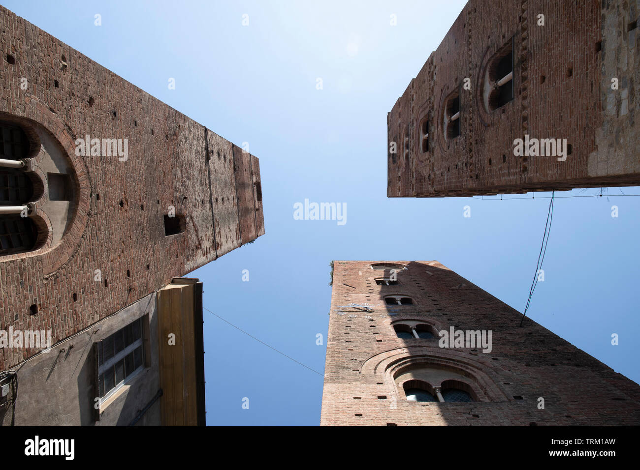The three towers, symbol of the town of Albenga, Liguria, Italy. Blue sky, down-top perspective. Stock Photo