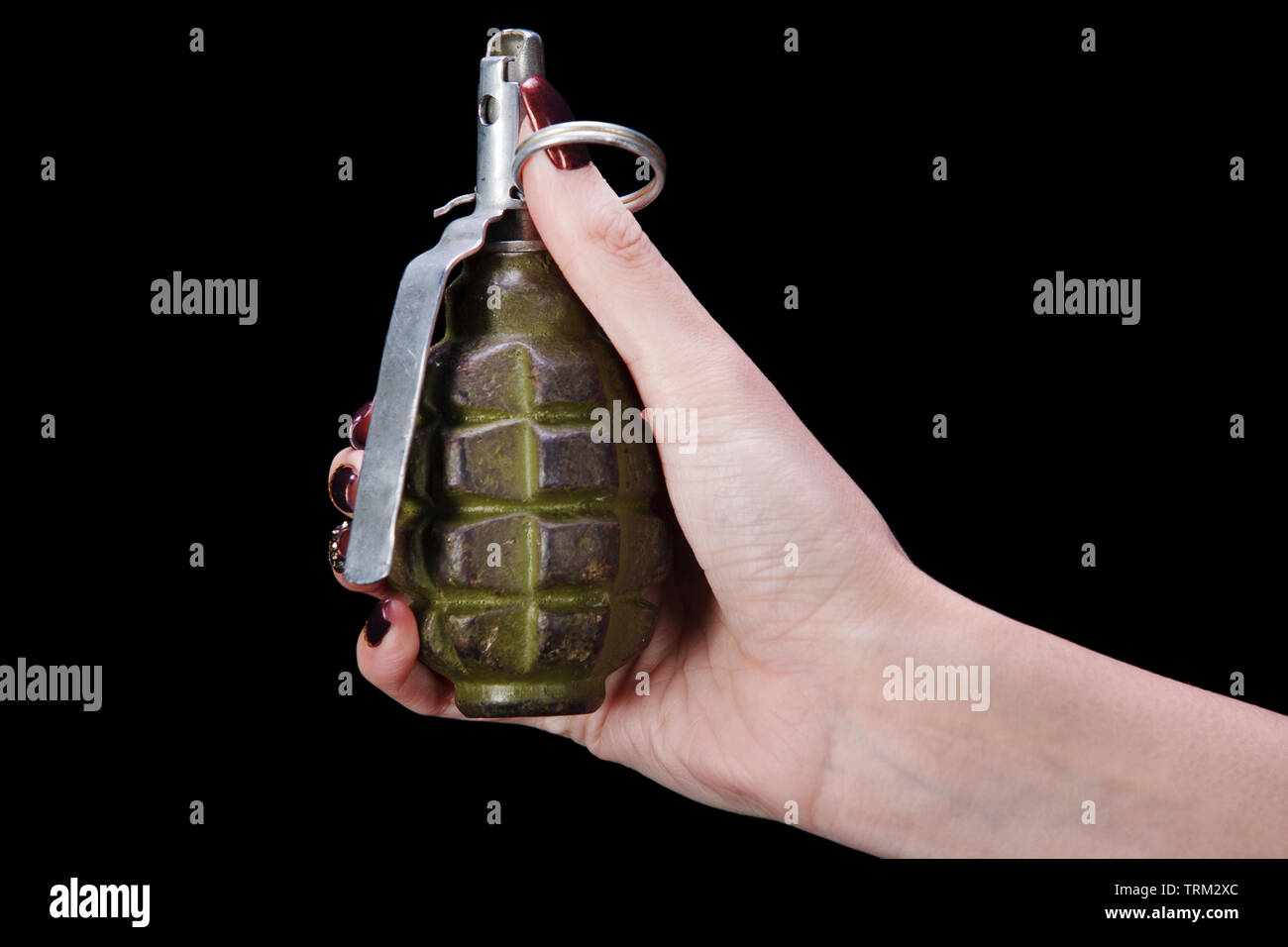 hand grenade in girl hand on black background Stock Photo