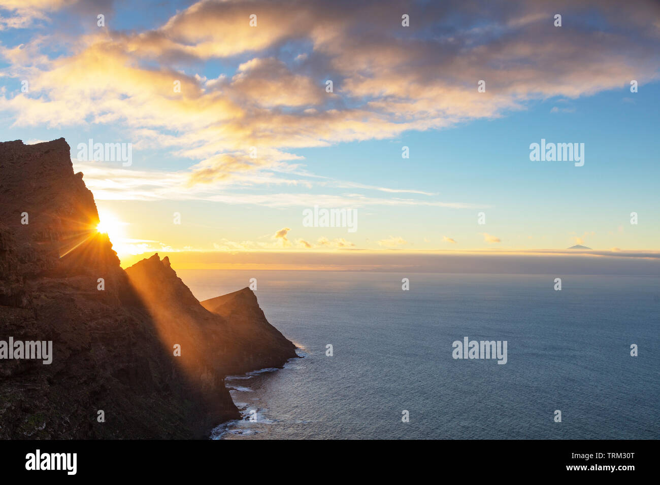 Europe, Spain, Canary Islands, Gran Canaria, west coast scenery at sunset and El Teide peak on Tenerife Stock Photo