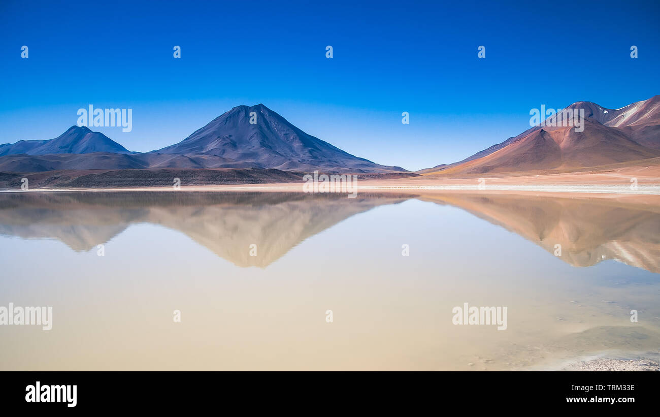 Andean mountains reflected in the lake near San Pedro de Atacama in Chile Stock Photo